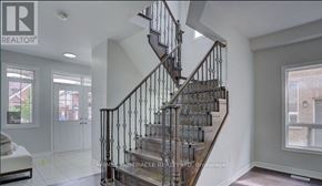 Clarington (Bowmanville) apartment for rent - A staircase with a metal railing and wooden steps.