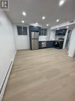 Whitby apartment for rent - A spacious kitchen with wooden flooring and modern appliances.