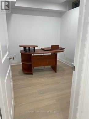 Whitby apartment for rent - A room with a table and a cabinet.