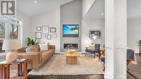 London North (North M) apartment for rent - A living room with a couch, a coffee table, a fireplace, and a television.