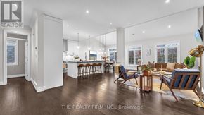 London North (North M) apartment for rent - A well-lit, spacious living room with a dining area and a kitchen in the background.