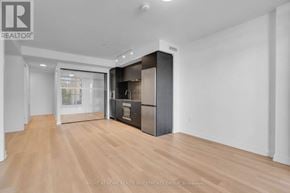 Hamilton (Beasley) condo for rent - A spacious room with wooden flooring and a large, dark-colored cabinet with a glass door.