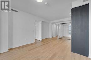 Hamilton (Beasley) condo for rent - A room with wooden floors and white walls, with a door open to another room.