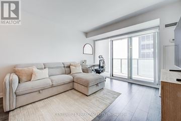 Toronto (Yonge-St. Clair) condo for rent - A living room with a couch and a large window.