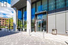 Toronto (Yonge-St. Clair) condo for rent - The entrance to a building with a glass door and a sign that reads "99 Fox".