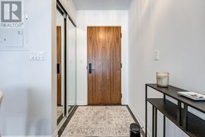 Toronto (Yonge-St. Clair) condo for rent - A hallway with a wooden door and a sign that says REALTOR.