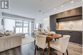 Toronto (Yonge-St. Clair) condo for rent - A modern dining room with a wooden table and white chairs.