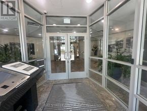 Toronto (Willowdale East) condo for rent - The image shows the front desk of a realtor office with glass walls and a sign that reads "REALTOR".
