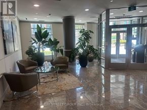 Toronto (Willowdale East) condo for rent - A lobby with a glass table and chairs.