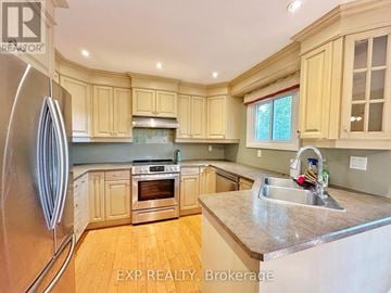 Aurora (Aurora Highlands) apartment for rent - A kitchen with wooden cabinets and a stainless steel refrigerator.