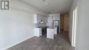 Vaughan (Vellore Village) condo for rent - A realtor photo of a kitchen with white cabinets and a wooden floor.