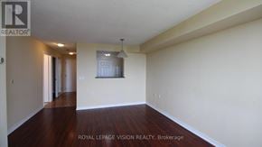 Toronto (Agincourt North) condo for rent - A spacious room with wooden floors and white walls.