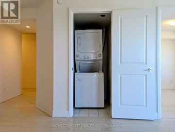 Toronto (Etobicoke West Mall) condo for rent - A white door is open to a small kitchen with a dishwasher and a microwave.