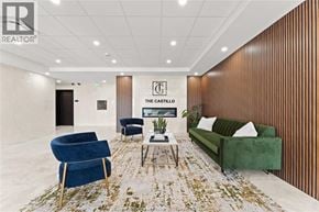 Windsor condo for rent - A living room with a green couch, blue armchair, and a coffee table.