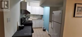 Toronto (Willowdale East) apartment for rent - A kitchen with a refrigerator, sink, and cabinets.