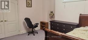 Toronto (Willowdale East) apartment for rent - A bedroom with a bed, nightstand, chair, and lamp.