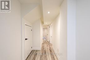 Georgina (Keswick South) apartment for rent - A long hallway with white walls and wood flooring.