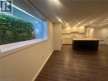 Hamilton apartment for rent - A kitchen with white cabinets and a black island.
