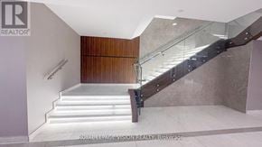 Mississauga (Hurontario) condo for rent - A staircase with a glass railing and wooden steps.