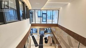Mississauga (Hurontario) condo for rent - A spacious room with a glass wall and a view of the outside.