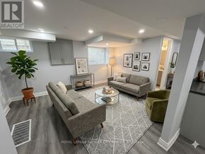 London North (North N) apartment for rent - A living room with a grey sofa and a green armchair.