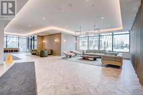 Toronto (Banbury-Don Mills) condo for rent - A spacious living room with a grey rug and a wooden floor.
