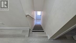 St. Catharines (E. Chester) triplex for rent - A staircase with a light at the end.