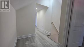 St. Catharines (E. Chester) triplex for rent - A white hallway with a staircase leading to the second floor.