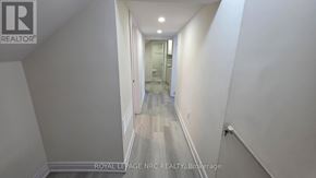 St. Catharines (E. Chester) triplex for rent - A long hallway with a door at the end.