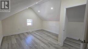 St. Catharines (E. Chester) triplex for rent - A room with a window and wooden flooring.