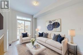 Richmond Hill (Oak Ridges) townhouse for rent - A living room with a white couch, a coffee table, and a painting on the wall.