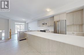 Richmond Hill (Oak Ridges) townhouse for rent - A modern kitchen with a large island and stainless steel appliances.
