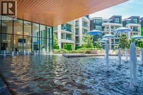 Vancouver apartment for rent - A fountain in the middle of a plaza with a building in the background.