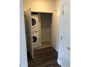 Surrey apartment for rent - A white door is open to reveal a laundry room with a washer and dryer.