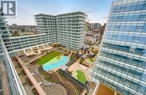 Richmond apartment for rent - A modern building with a pool and a glass facade.