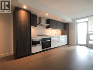 Richmond apartment for rent - A modern kitchen with dark wood cabinets and white appliances.