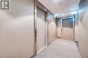Toronto (Waterfront Communities) condo for rent - A hallway with doors on either side and a sign on the wall that says "EXIT".