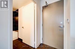 Toronto (Waterfront Communities) condo for rent - A white door is open to a bathroom.