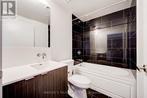 Toronto (Waterfront Communities) condo for rent - A bathroom with a white toilet and a white bathtub.
