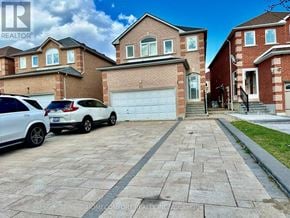 Markham (Middlefield) apartment for rent - A white car is parked in front of a house with a garage.
