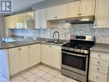 Markham (Middlefield) apartment for rent - A kitchen with white cabinets and a stainless steel oven.