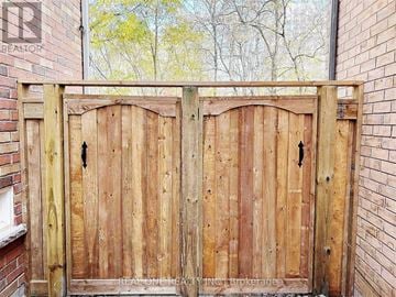 Markham (Wismer) apartment for rent - A wooden gate with a brick wall on either side.