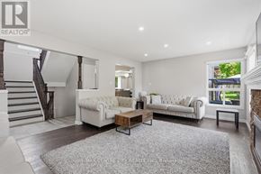 London East (East A) apartment for rent - A spacious living room with a staircase and two white sofas.