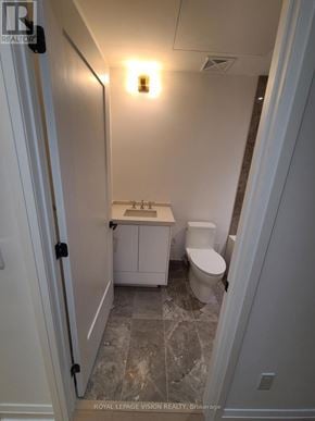Toronto (Englemount-Lawrence) condo for rent - A white toilet and sink in a small bathroom.