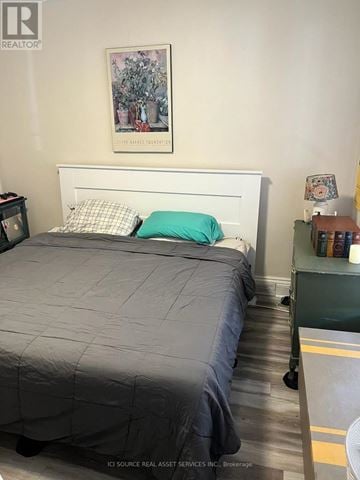Hamilton (St. Clair) duplex for rent - A bedroom with a bed, nightstand, and a painting on the wall.