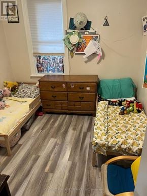 Hamilton (St. Clair) duplex for rent - A room with two beds, a dresser, and a chair.