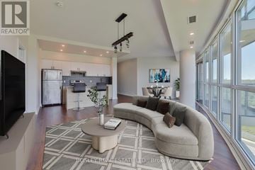 Toronto (Leaside) condo for rent - A living room with a large couch and a television.