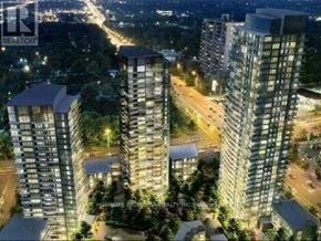 Toronto (Henry Farm) condo for rent - A nighttime cityscape with illuminated buildings and a REALTOR sign.