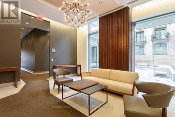Toronto (Niagara) condo for rent - A living room with a white couch and a wooden coffee table.