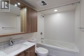 Toronto (Niagara) condo for rent - A bathroom with a white sink and a white toilet.